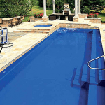 A pool with a blue cover and a deck
