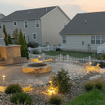 A fire pit in the middle of a backyard.