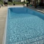 A pool with water in it and no people around.